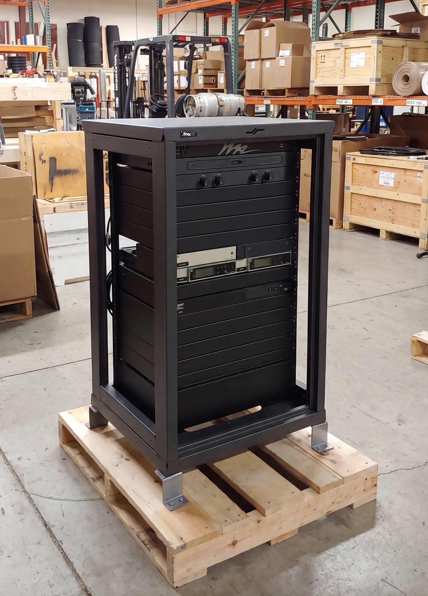 Equipment rack secured to a pallet in a warehouse